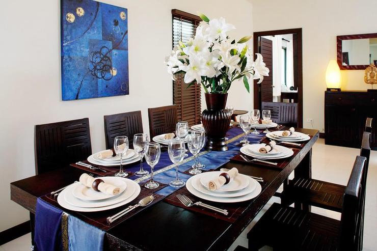 The teak dining table, comfortably seating 8 guests, is perfect for enjoying delicious Thai in house cuisine