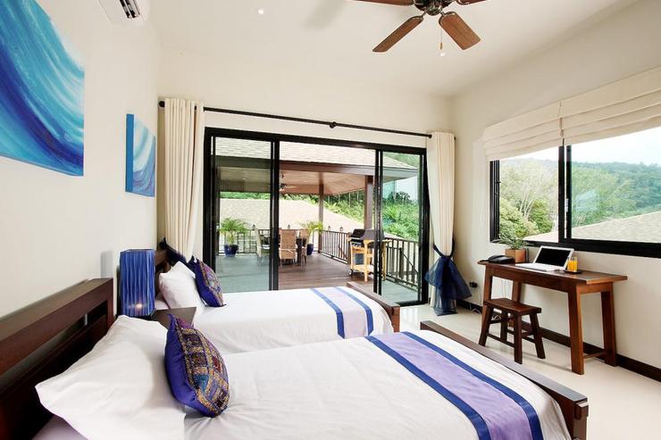 Bedroom 4 with twin single beds and direct access to the sun deck and swimming pool