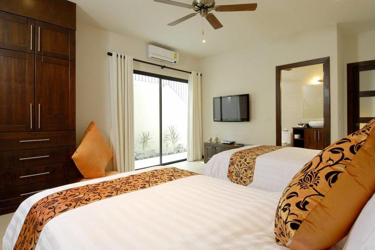 Bedroom 5 with air conditioning, ceiling fan, en-suite bathroom and direct access to the outside