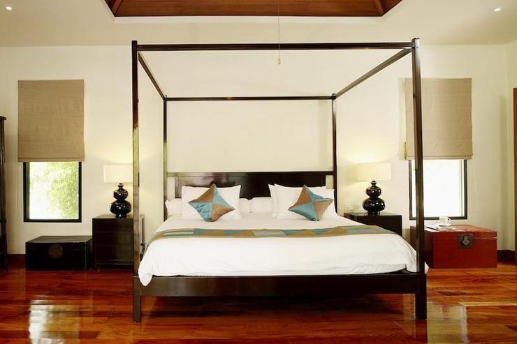Master bedroom with vaulted ceiling and super king-size four-poster bed