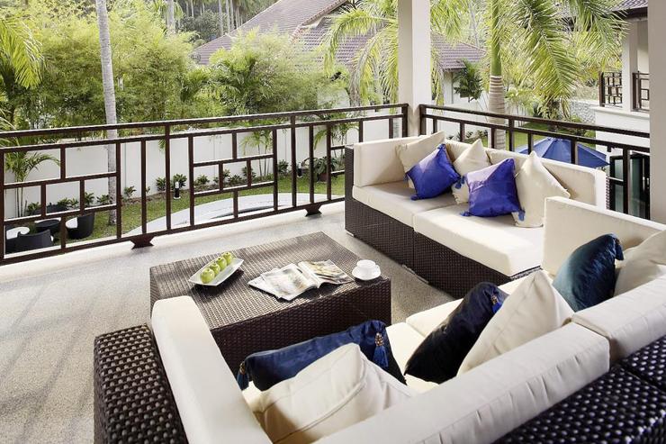 Outside balcony with comfortable seating and a view across to garden and swimming pool