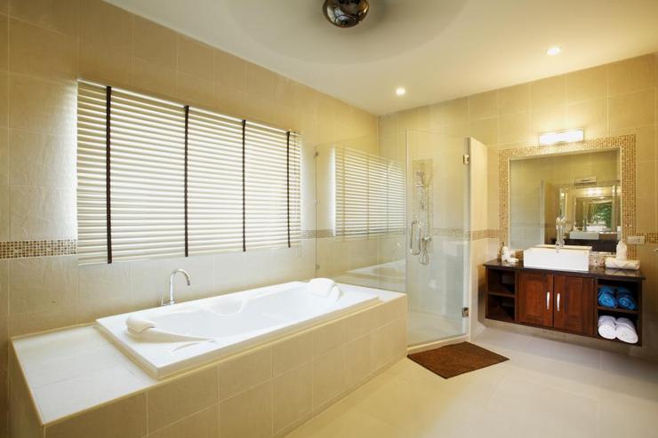 Master en-suite bathroom complete with bath, walk in shower and twin wash hand basins