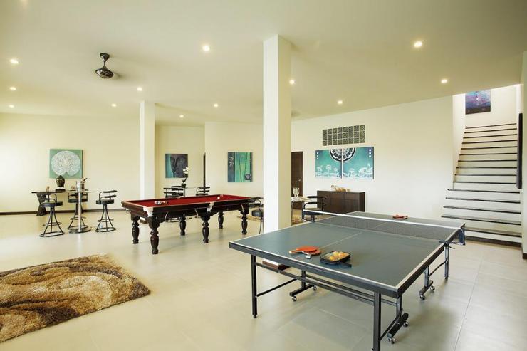 Extensive games room with table tennis table, pool table, bar area and gym equipment
