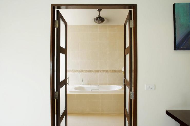 Bedroom 2 en-suite bathroom with bath, walk in shower and twin wash hand basins