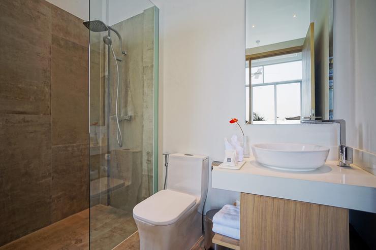 Bedroom 1's en-suite bathroom features contemporary fittings, luxurious marble tiles and shower enclosure with both rail and rain showers.